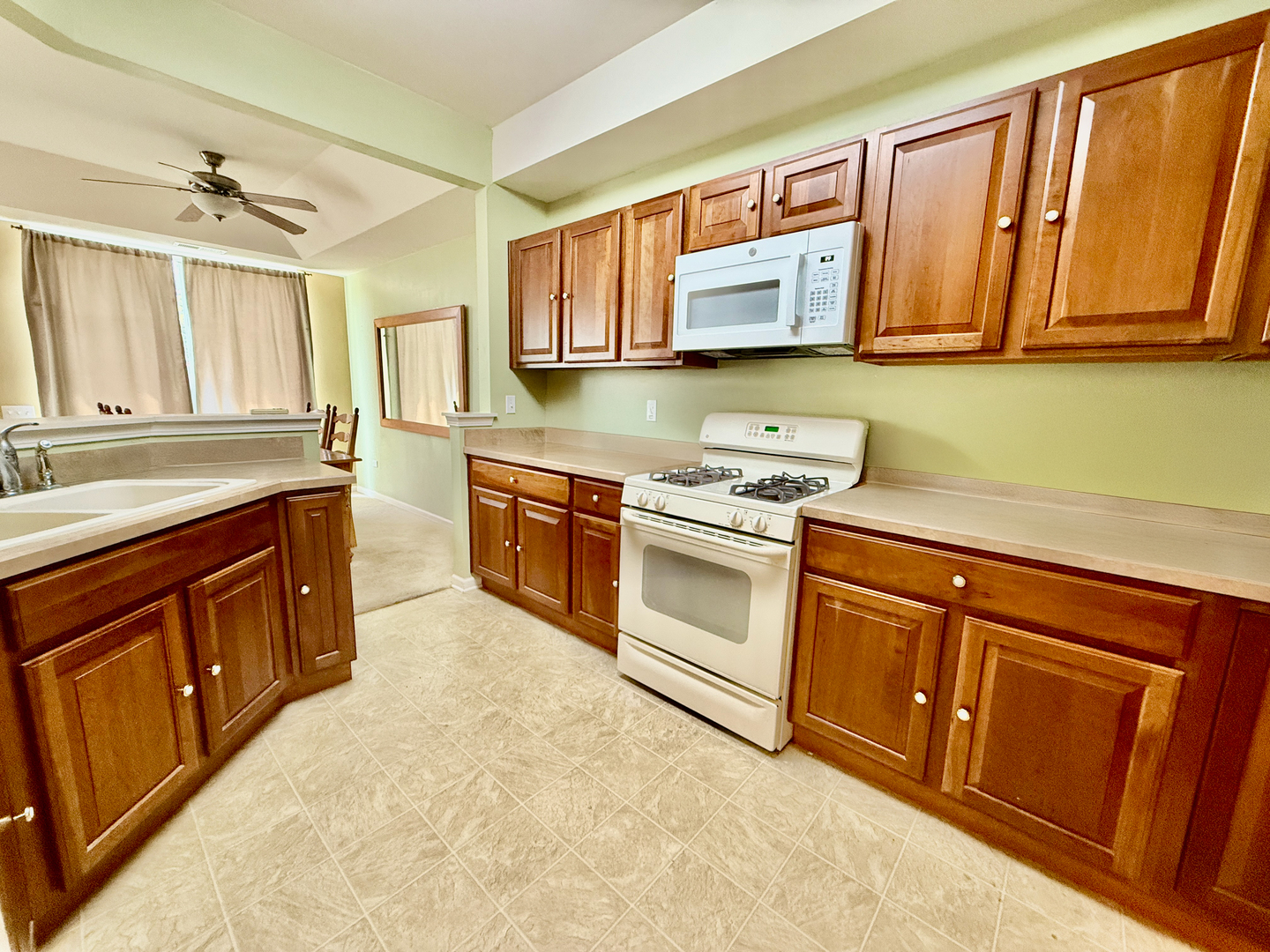13455 Nealy Road Huntley, IL 60142 - Photo 6 of 16 a kitchen with stainless steel appliances granite countertop wooden cabinets a stove top oven a sink and dishwasher