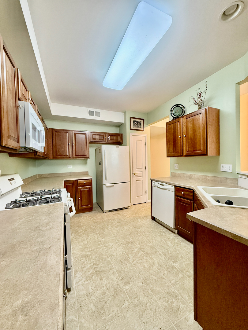 13455 Nealy Road Huntley, IL 60142 - Photo 7 of 16 a kitchen with a cabinets and appliances