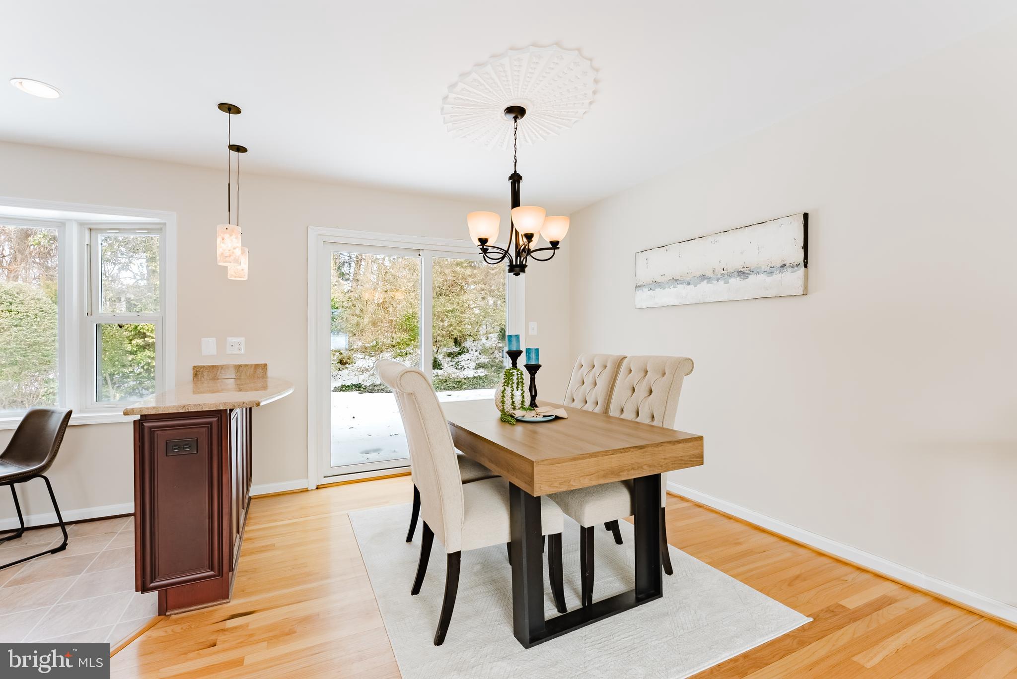 4704 Federal Court Annandale, VA 22003 - Photo 13 of 51 a dining room with furniture a chandelier and wooden floor
