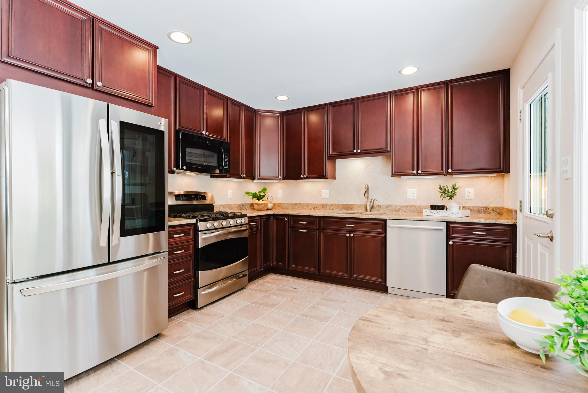 4704 Federal Court Annandale, VA 22003 - Photo 15 of 51 a kitchen with stainless steel appliances granite countertop a refrigerator sink and cabinets