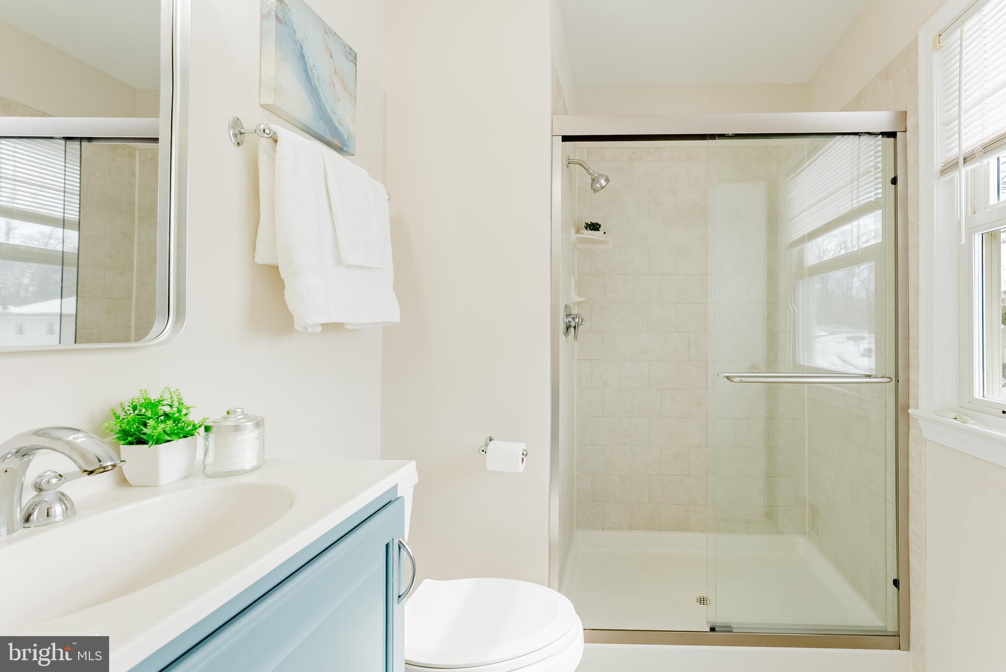 4704 Federal Court Annandale, VA 22003 - Photo 26 of 51 a bathroom with a granite countertop sink mirror and a shower