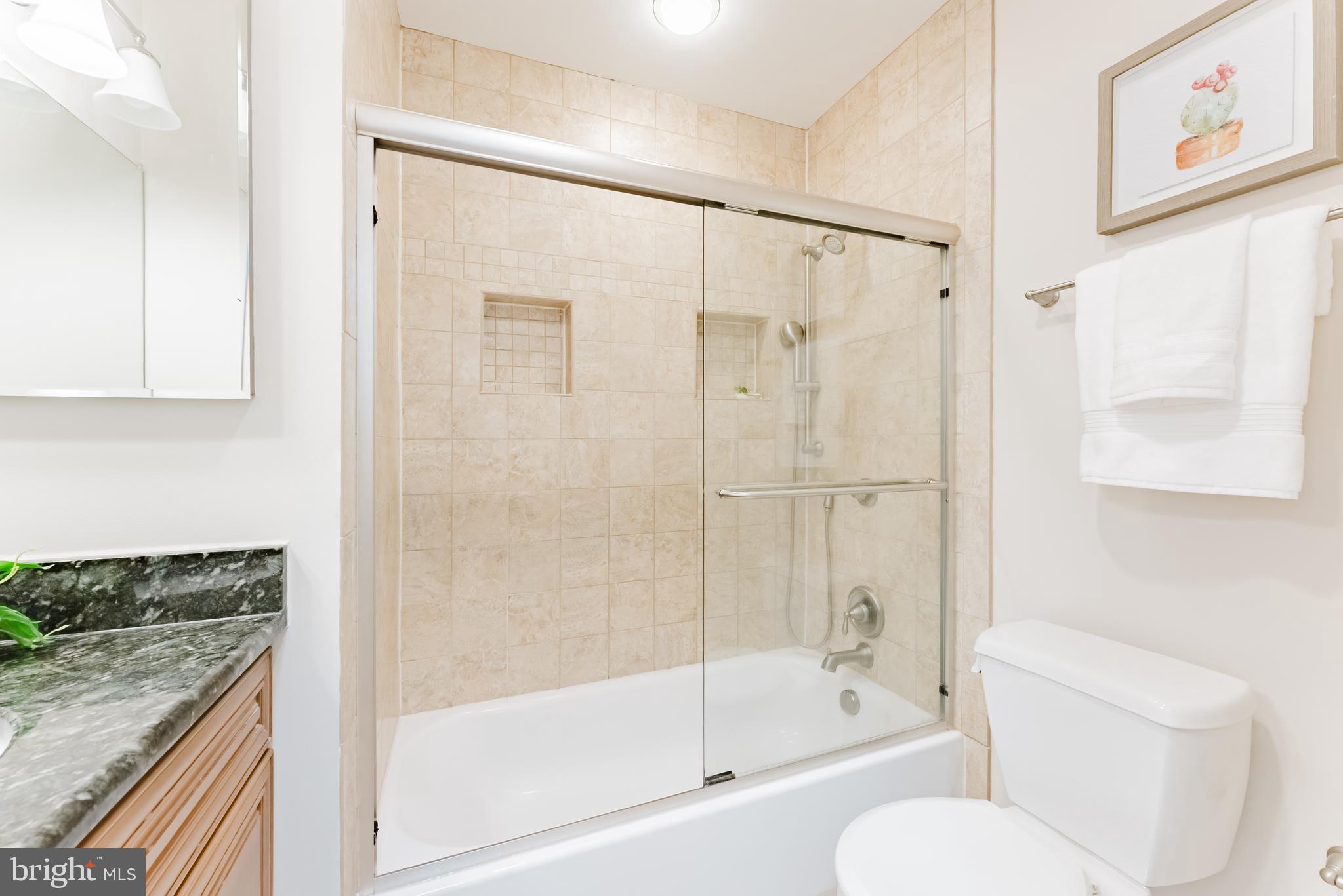4704 Federal Court Annandale, VA 22003 - Photo 30 of 51 a bathroom with a granite countertop bathtub shower sink vanity and toilet