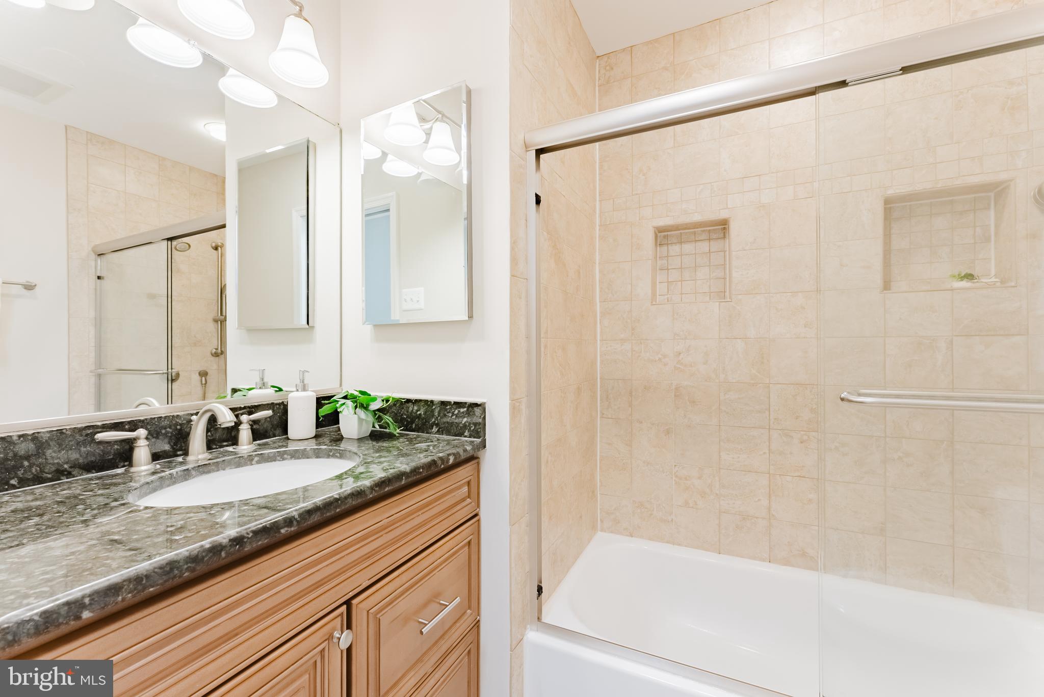 4704 Federal Court Annandale, VA 22003 - Photo 31 of 51 a bathroom with a granite countertop sink mirror and a bathtub