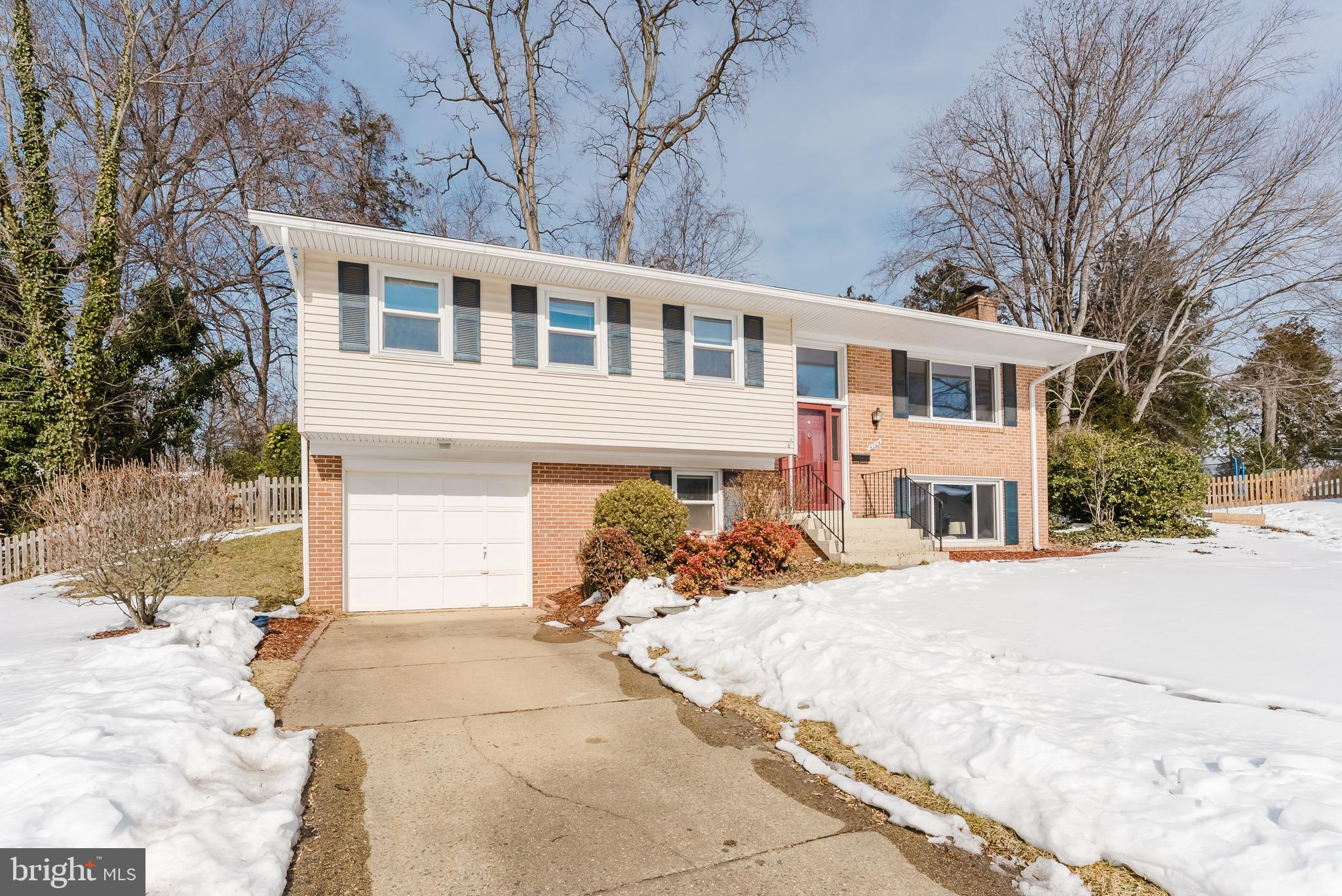 4704 Federal Court Annandale, VA 22003 - Photo 43 of 51 a front view of a house with a yard covered with snow and trees