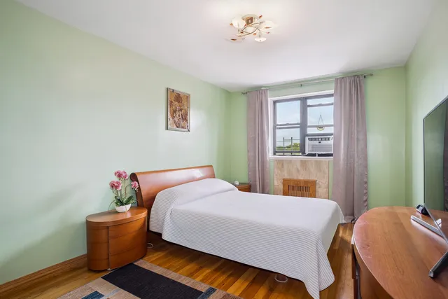 a view of a hallway with closet and wooden floor
