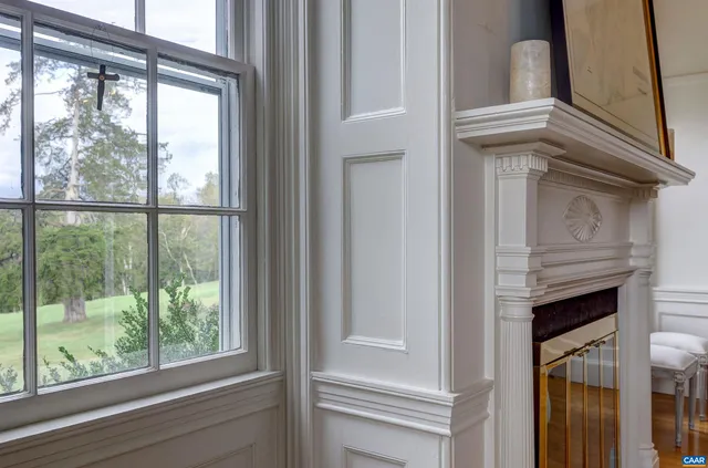 a dining room with furniture a fireplace and wooden floor