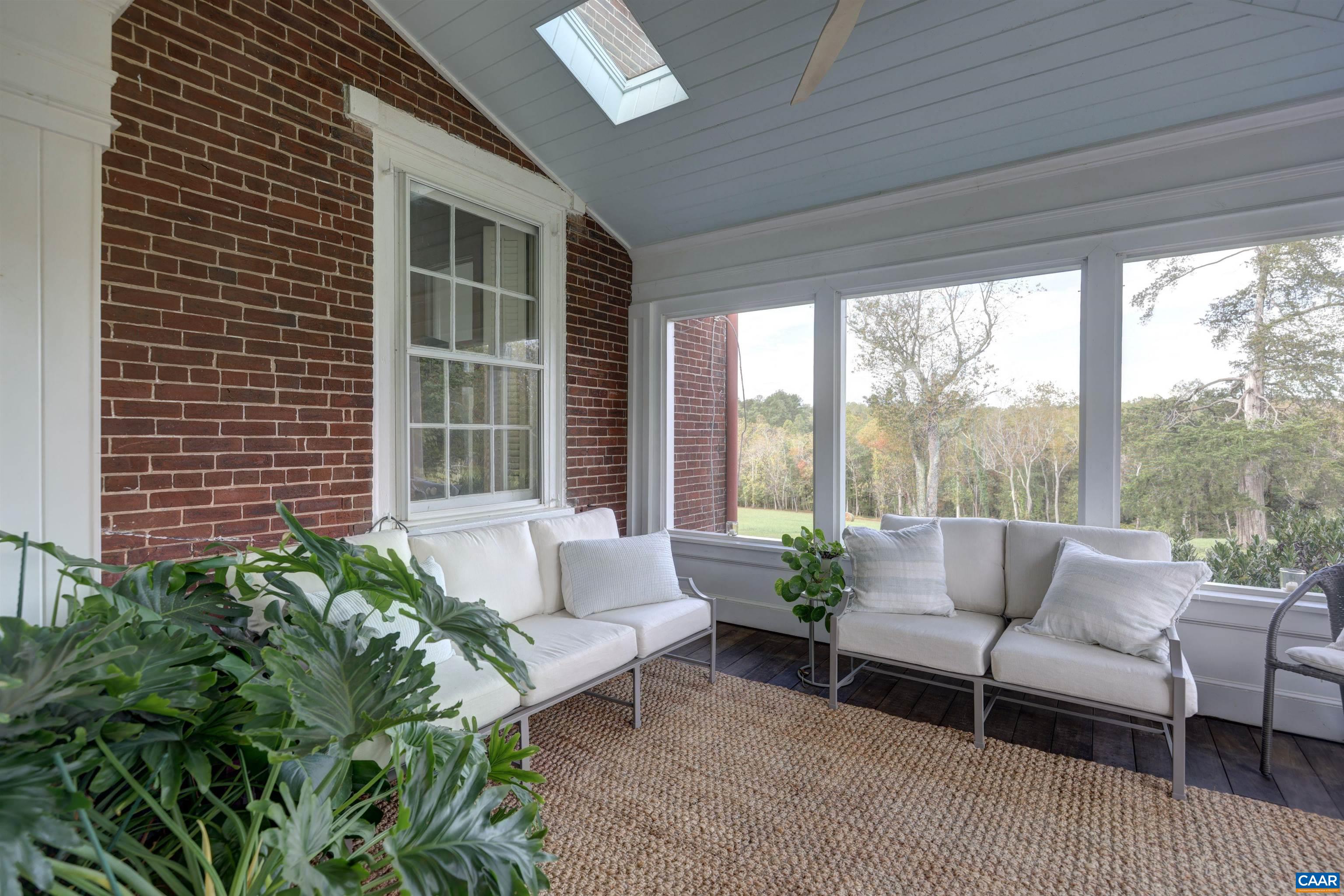 4710 Dickerson Road Earlysville, VA 22936 - Photo 25 of 75 a living room with furniture and a potted plant