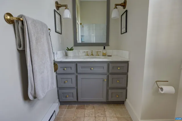 a bathroom with a sink a vanity and a mirror
