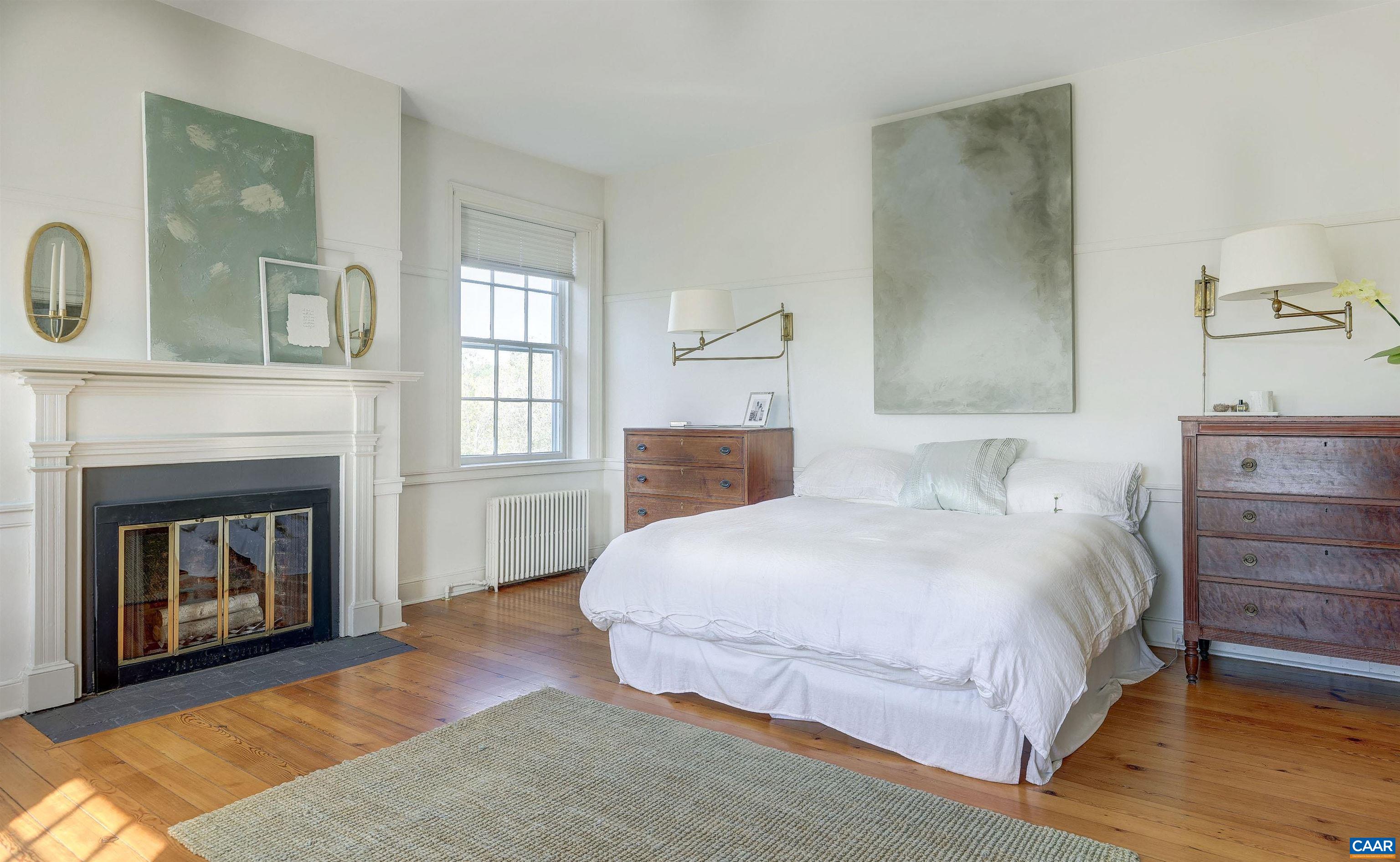 4710 Dickerson Road Earlysville, VA 22936 - Photo 35 of 75 a bedroom with a bed and a fireplace