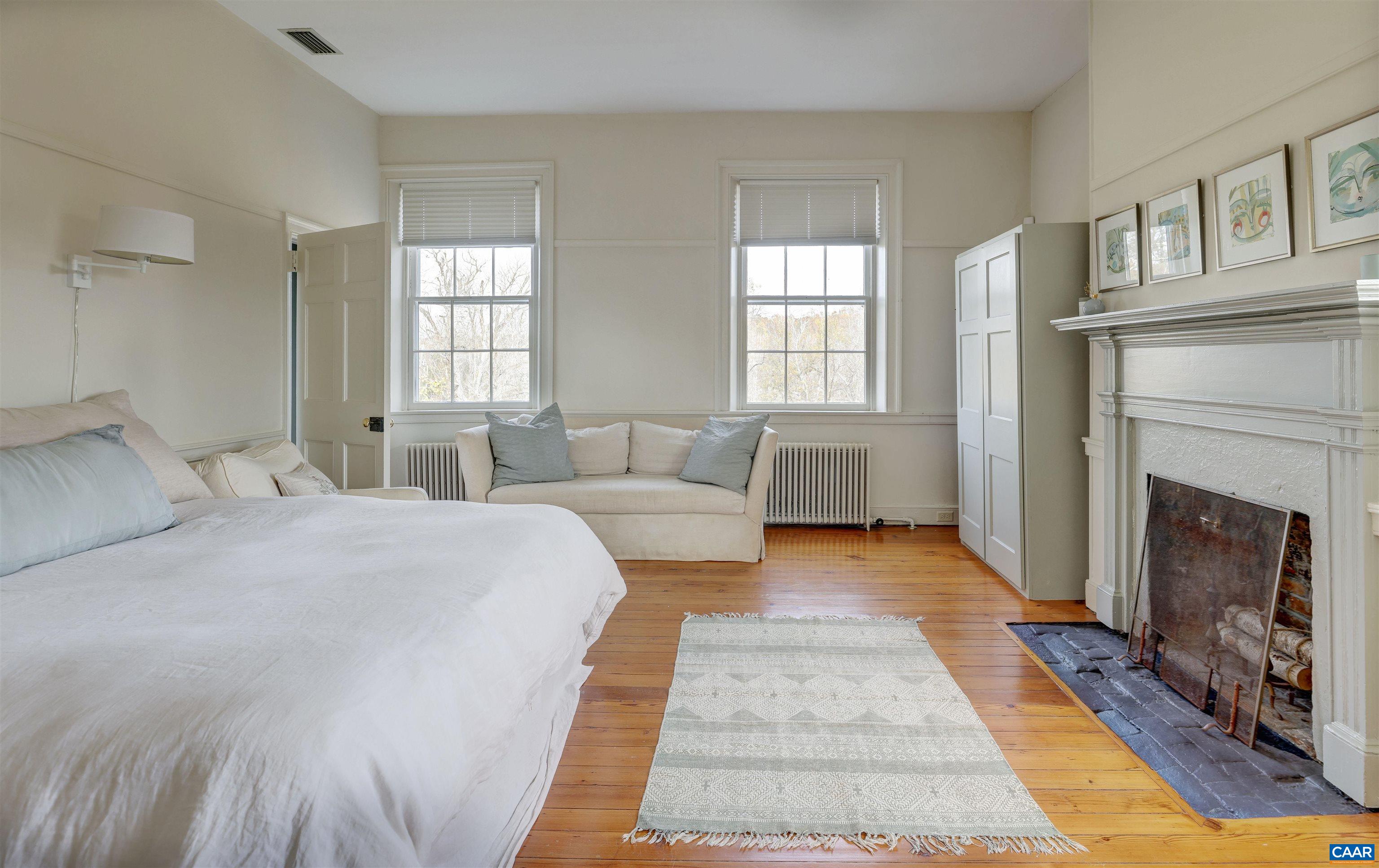 4710 Dickerson Road Earlysville, VA 22936 - Photo 37 of 75 a bed room with a bed and a fireplace