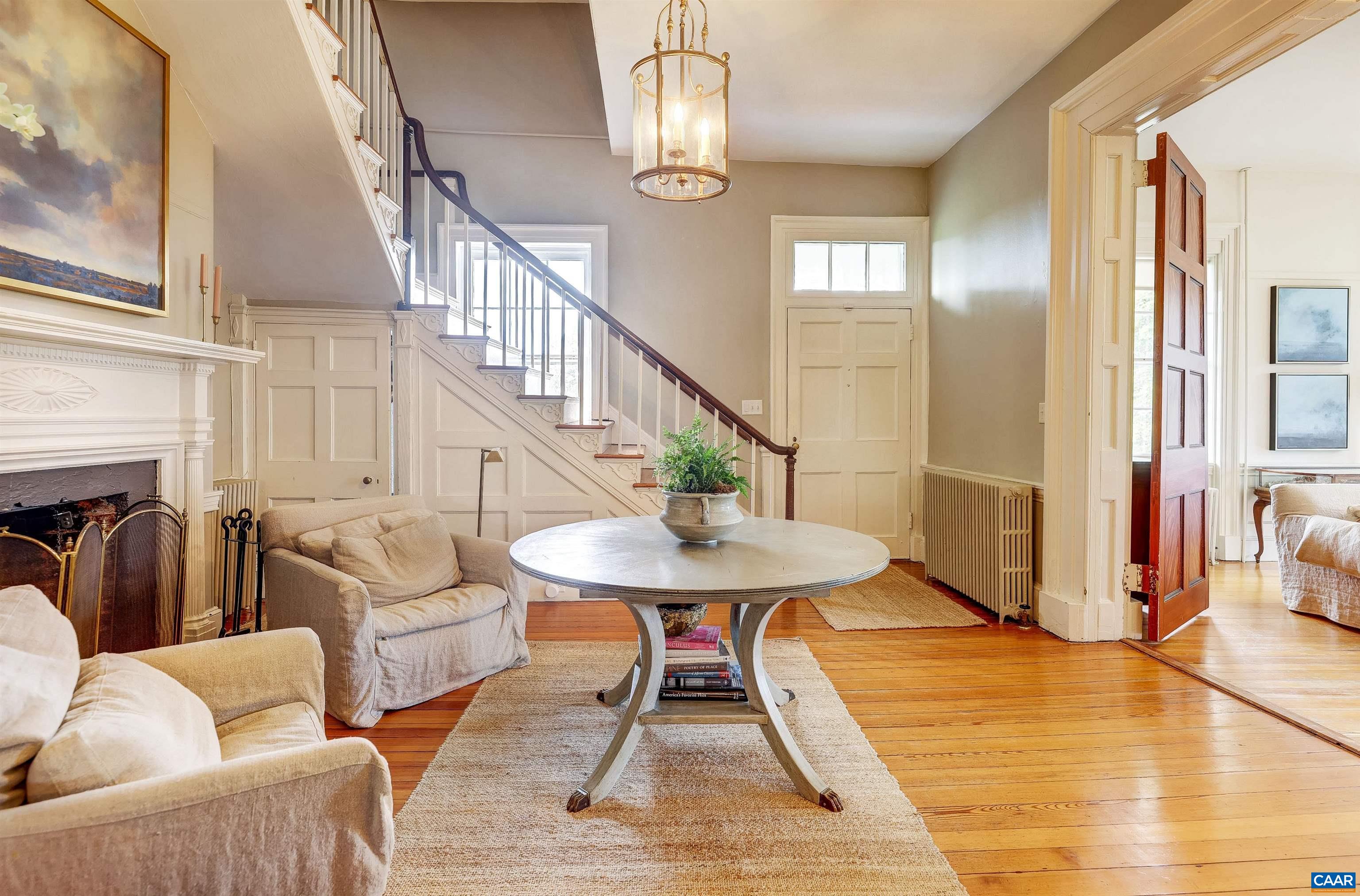 4710 Dickerson Road Earlysville, VA 22936 - Photo 5 of 75 a living room with furniture a table and wooden floor