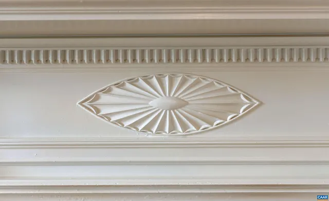 a dining room with furniture a chandelier and window