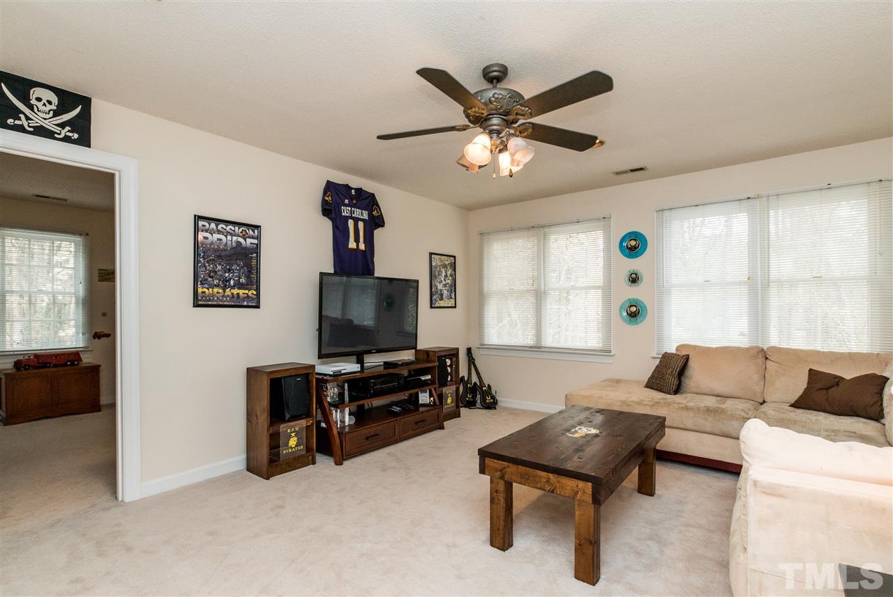 10828 Cahill Road Raleigh, NC 27614 - Photo 22 of 25 a living room with furniture and a flat screen tv
