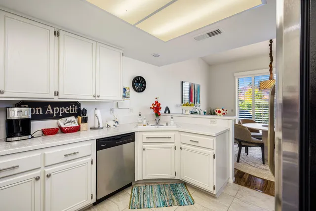 a dining room with furniture potted plants and wooden floor