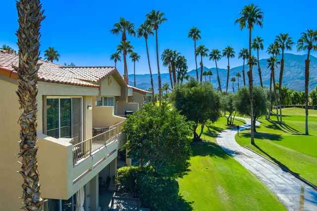 a view of a patio with table and chairs with wooden floor and fence