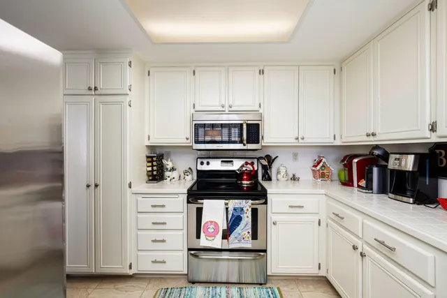 a kitchen with stainless steel appliances a stove microwave and cabinets