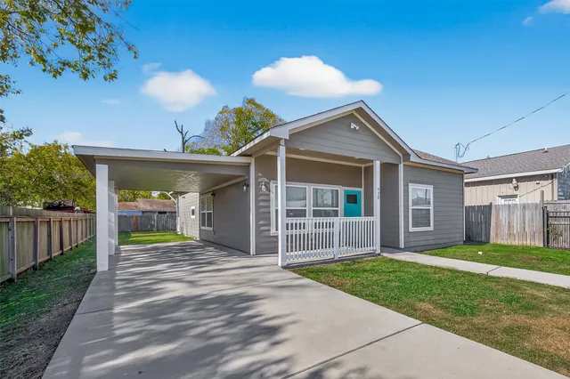 a view of a house with a yard and porch
