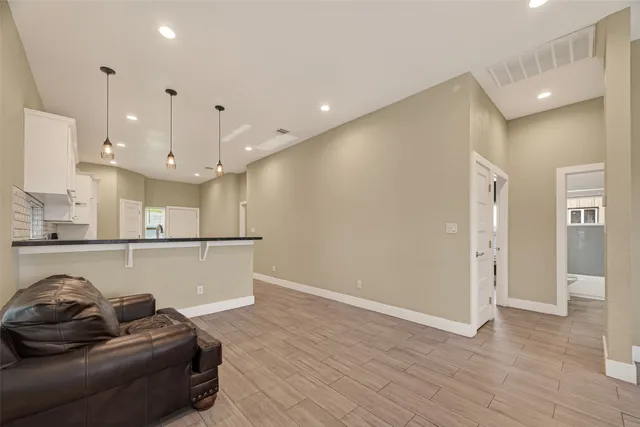 a living room with furniture and kitchen view