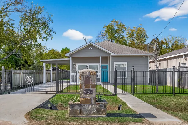 a front view of a house with a yard table and chairs