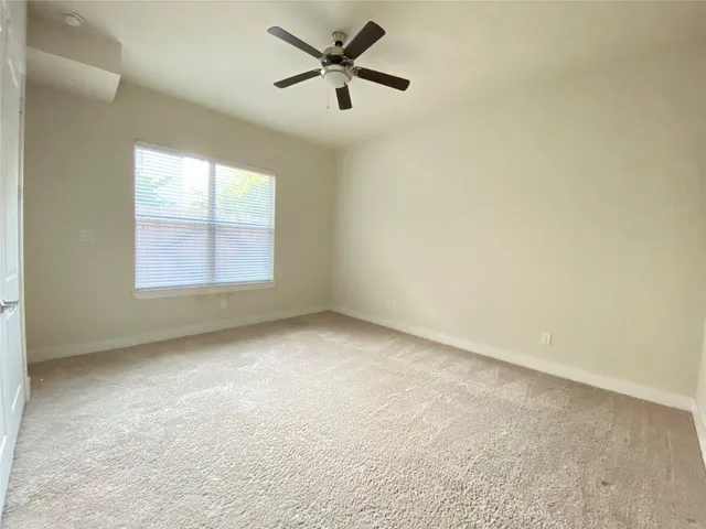 a bathroom with a granite countertop sink a toilet and a mirror