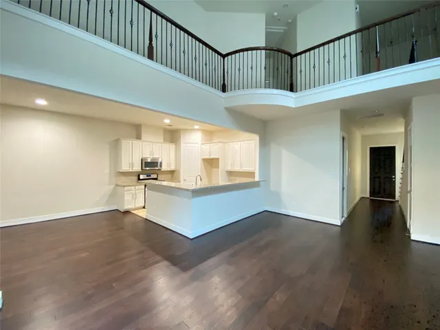 a view of a kitchen with wooden floor and a sink