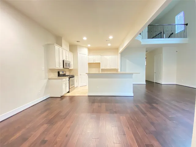 a kitchen with stainless steel appliances granite countertop a sink a stove top oven a counter space and cabinets