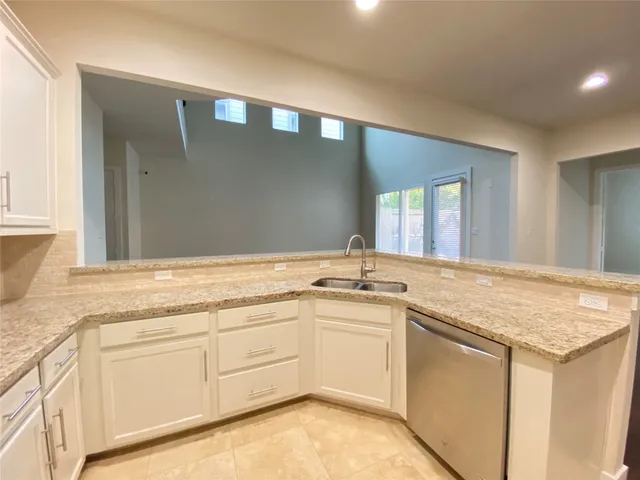 an empty room with a ceiling fan and window