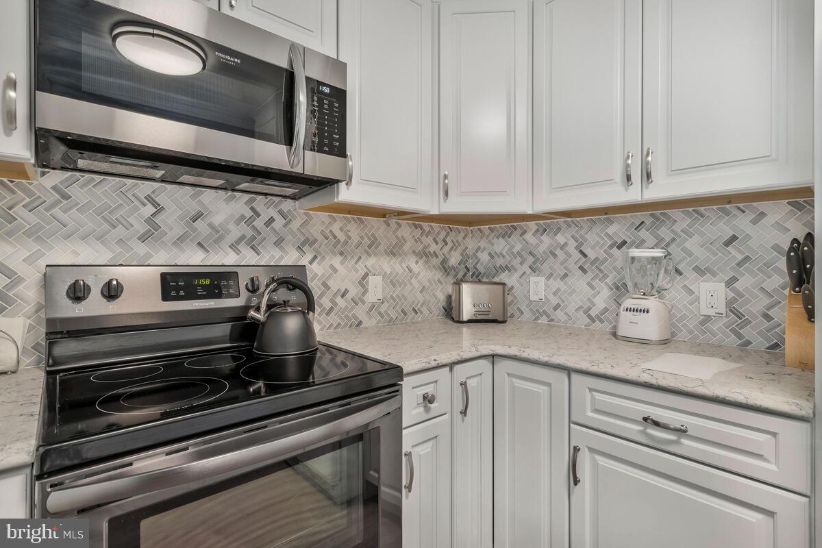 22 Robshire Manor Road Huntingtown, MD 20639 - Photo 12 of 44 a kitchen with stainless steel appliances granite countertop white cabinets and a stove top oven