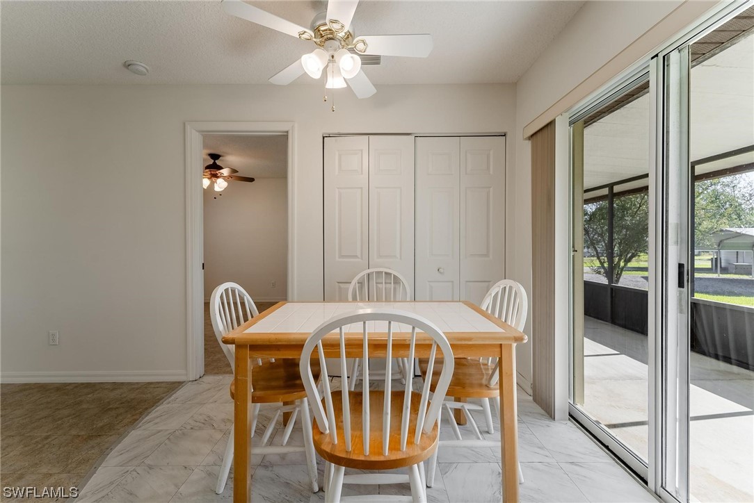 1140 Sealey Road Moore Haven, FL 33471 - Photo 11 of 29 a view of a dining room with furniture and chandelier