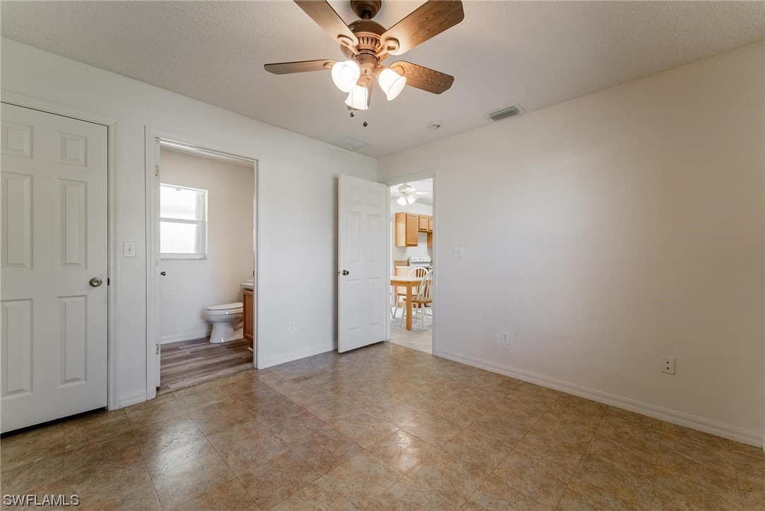 1140 Sealey Road Moore Haven, FL 33471 - Photo 15 of 29 wooden floor in an empty room and a ceiling fan
