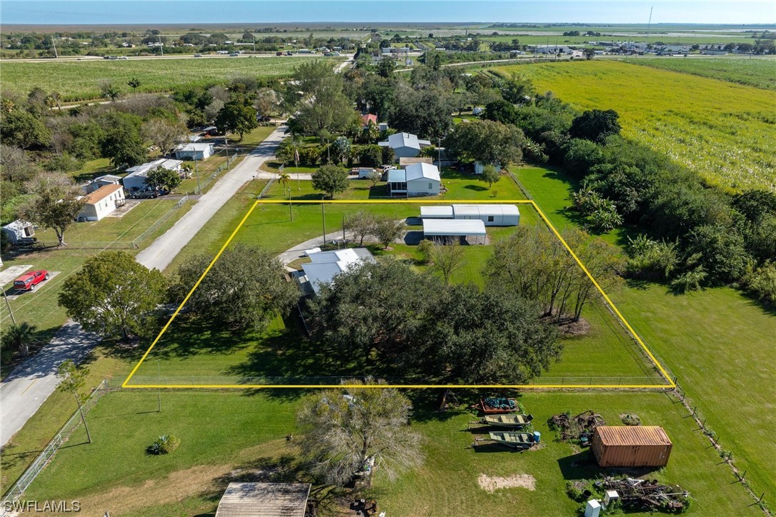 1140 Sealey Road Moore Haven, FL 33471 - Photo 27 of 29 a view of a swimming pool with a patio and a garden