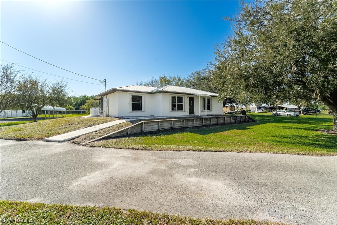 1140 Sealey Road Moore Haven, FL 33471 - Photo 3 of 29 a view of house with outdoor space and swimming pool