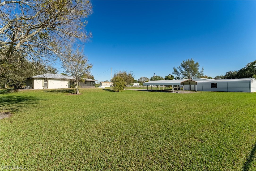 1140 Sealey Road Moore Haven, FL 33471 - Photo 4 of 29 a view of a house with a big yard