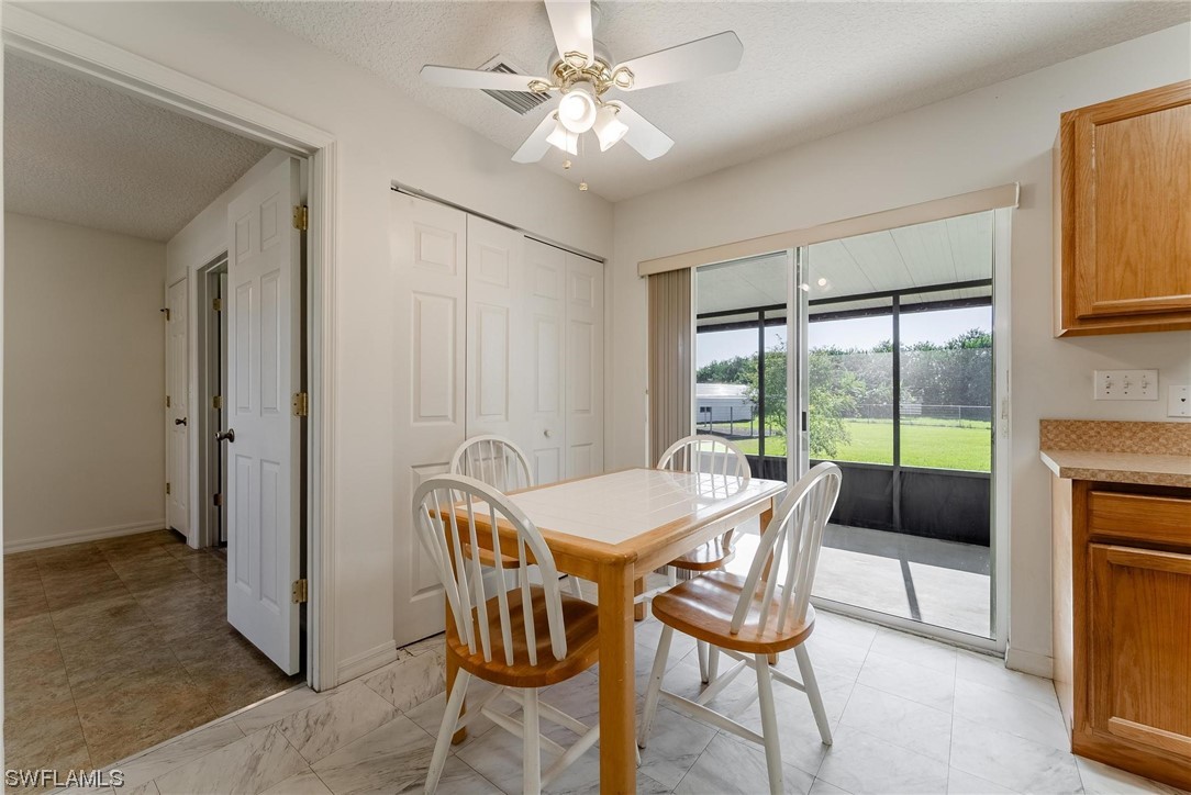 1140 Sealey Road Moore Haven, FL 33471 - Photo 10 of 29 a view of a dining room with furniture window and outside view