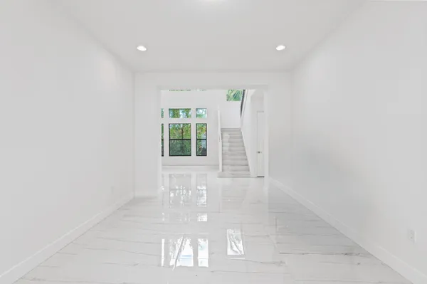 a kitchen with white cabinets and white appliances