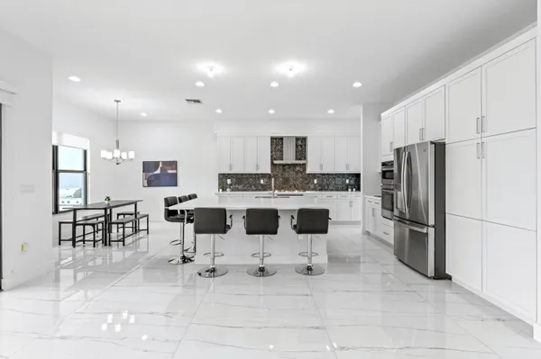 a dining room with furniture a chandelier and window