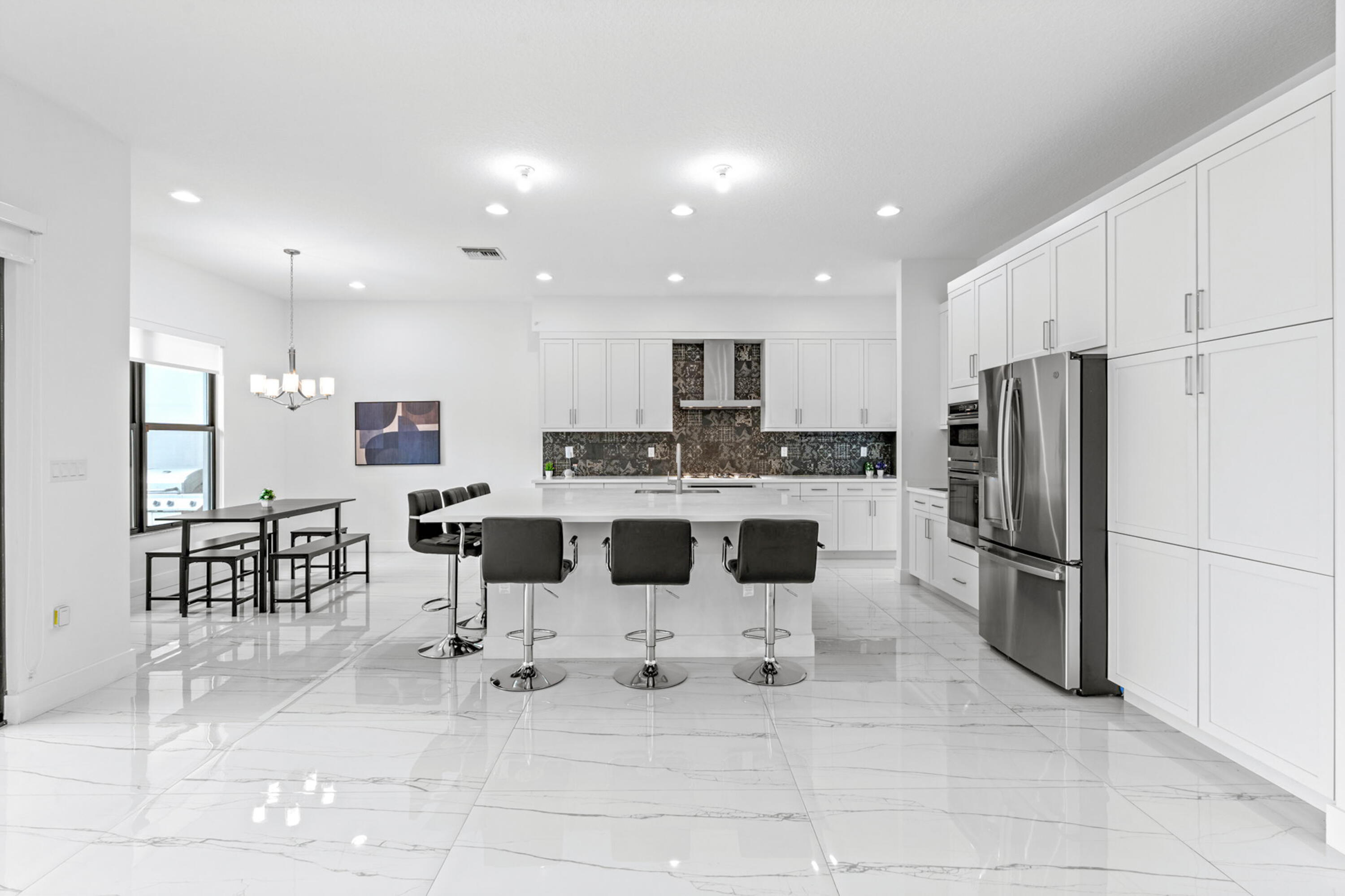 17117 Teton River Road Boca Raton, FL 33496 - Photo 12 of 67 a kitchen with stainless steel appliances kitchen island granite countertop a refrigerator and a stove top oven