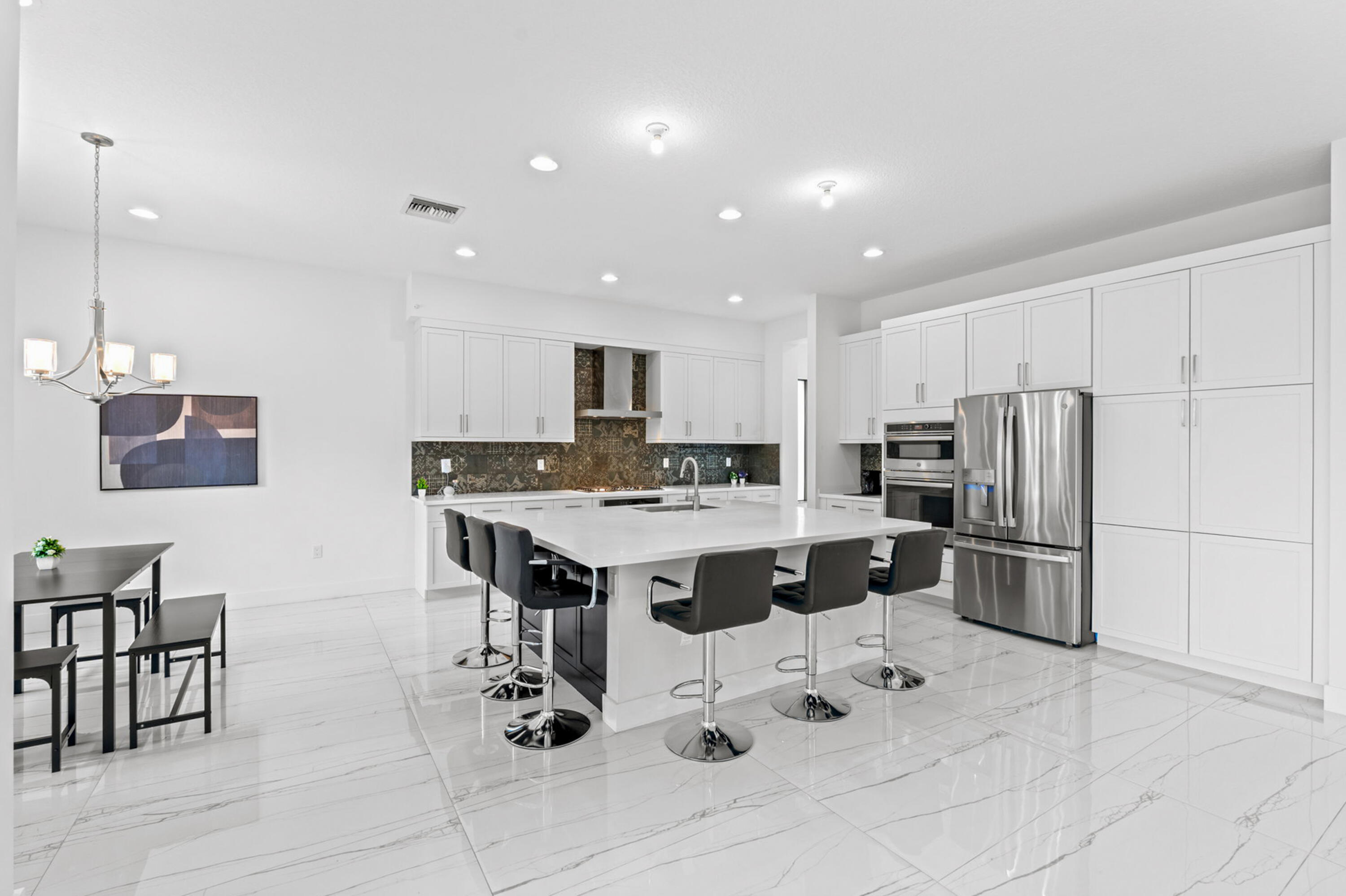 17117 Teton River Road Boca Raton, FL 33496 - Photo 13 of 67 a kitchen with stainless steel appliances kitchen island granite countertop a sink and cabinets