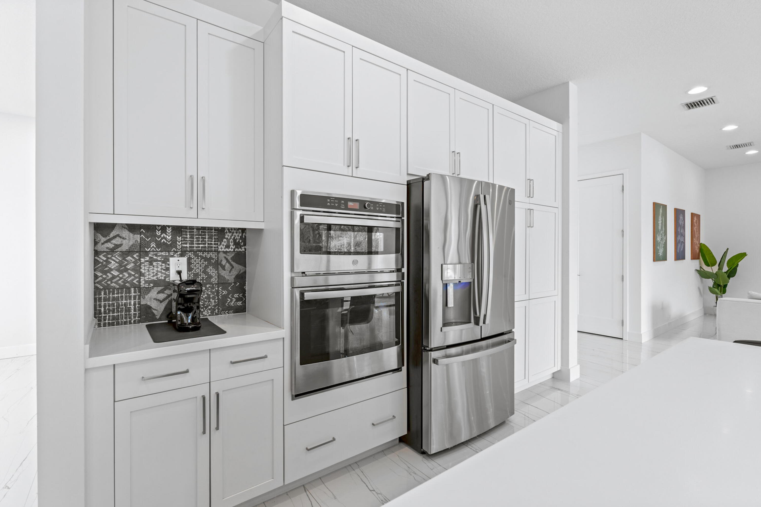 17117 Teton River Road Boca Raton, FL 33496 - Photo 15 of 67 a kitchen with stainless steel appliances white cabinets and a refrigerator