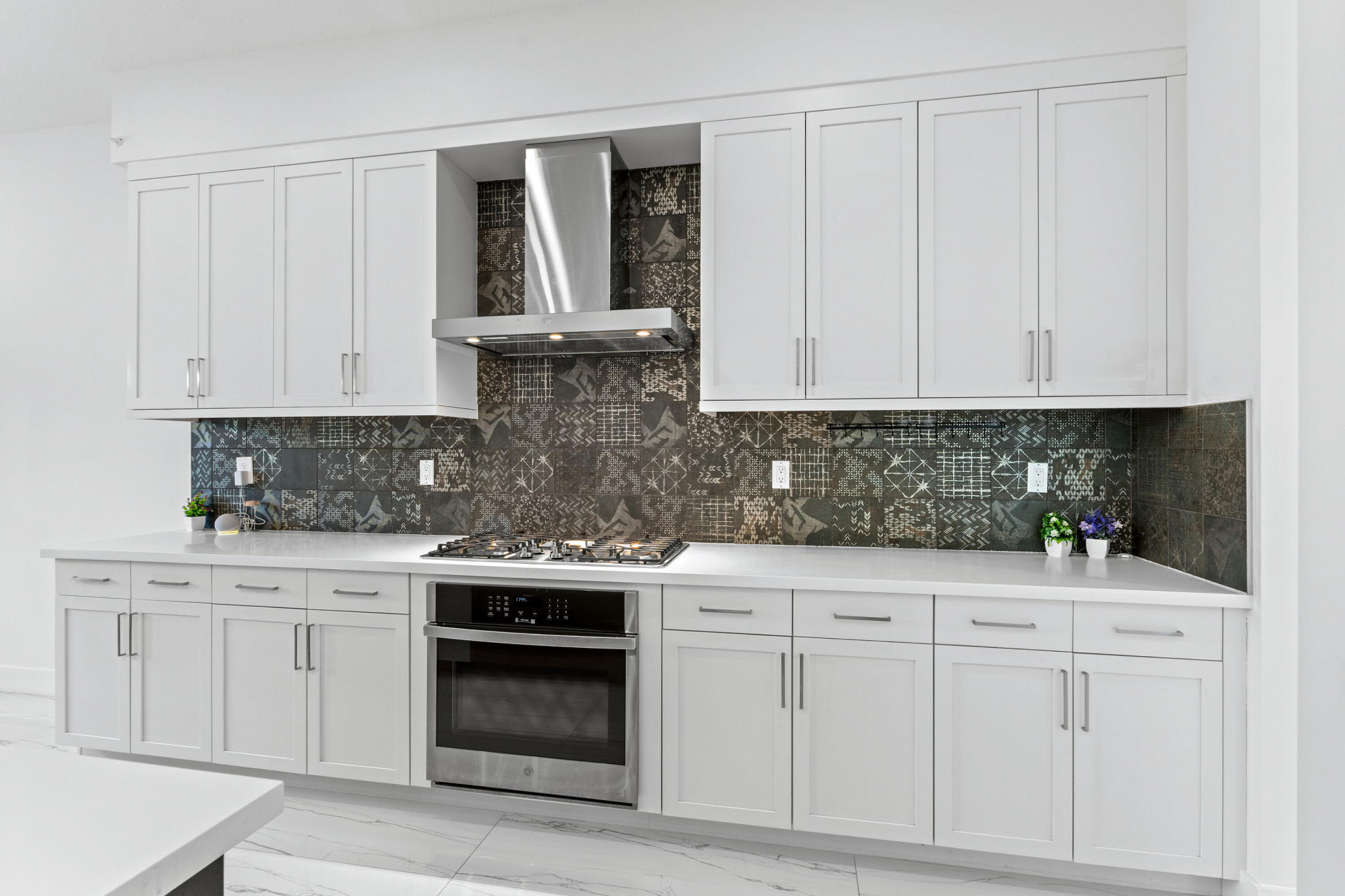 17117 Teton River Road Boca Raton, FL 33496 - Photo 16 of 67 a kitchen with white cabinets and white appliances