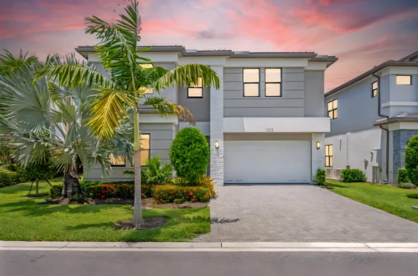 a front view of a house with a yard and garage