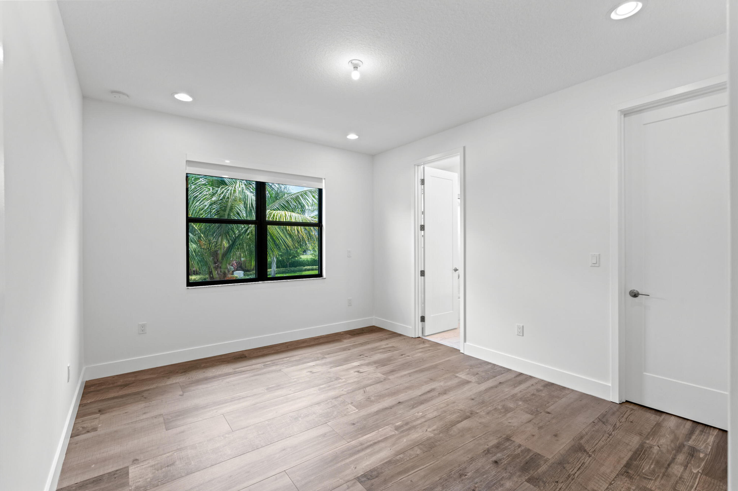 17117 Teton River Road Boca Raton, FL 33496 - Photo 37 of 67 an empty room with wooden floor and windows