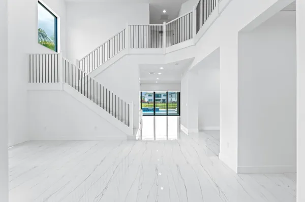 a view of entryway with wooden floor and a front door