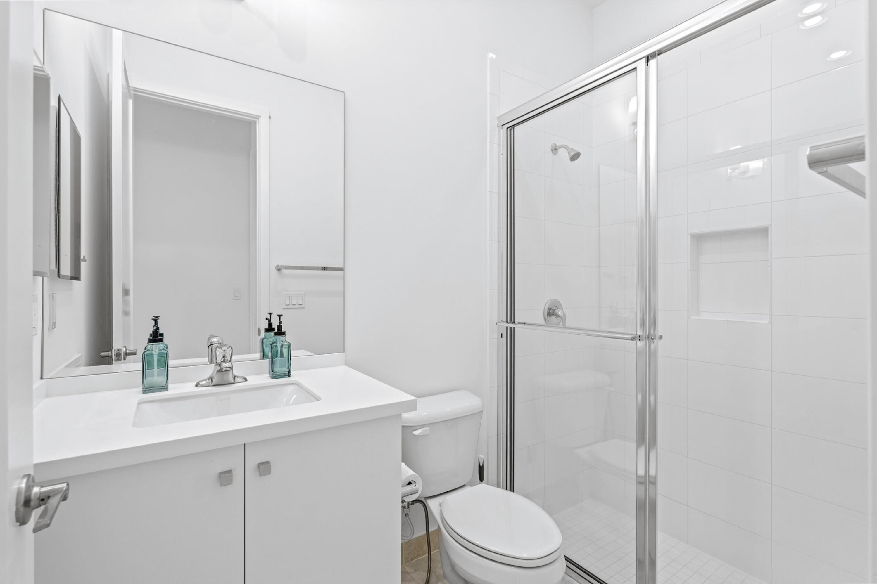17117 Teton River Road Boca Raton, FL 33496 - Photo 57 of 67 a bathroom with a sink a toilet a mirror and shower