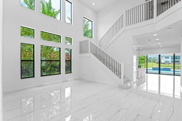 a kitchen with stainless steel appliances kitchen island granite countertop a refrigerator and a stove top oven