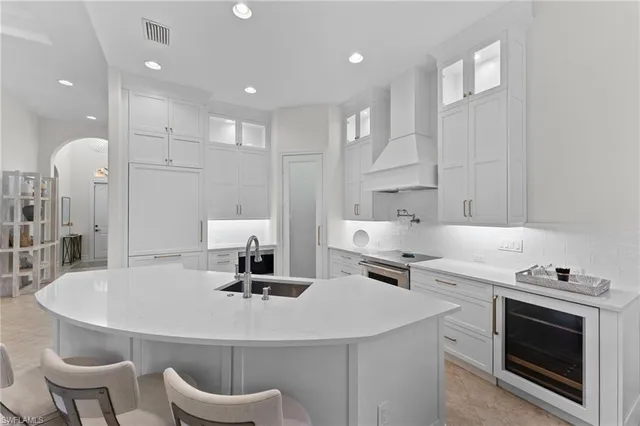 a kitchen with a table chairs sink and cabinets