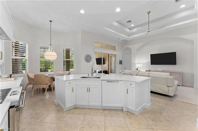 a large kitchen with a lot of white cabinets
