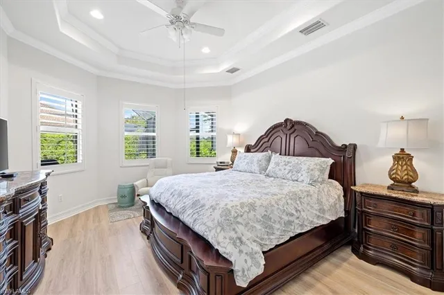 a bedroom with a bed and a dresser next to a window