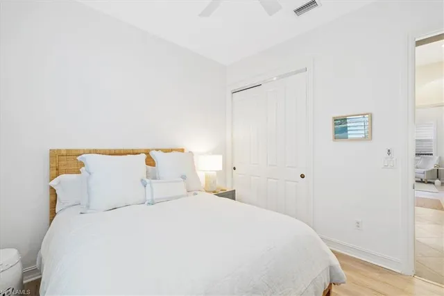 a bedroom with a bed and a night stand