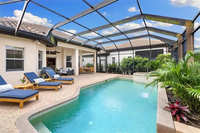 a view of swimming pool with outdoor seating and a patio